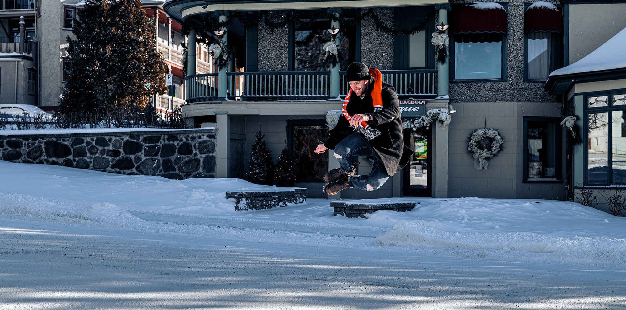 Max Parrot is snowboarding in the street